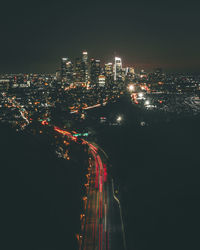 High angle view of illuminated buildings against sky at night