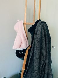 Clothes drying on clothesline against wall at home