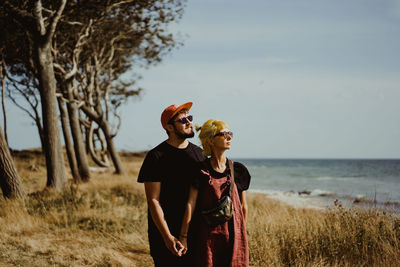 Man and woman standing on seaside