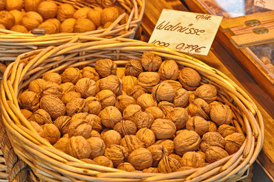 High angle view of walnuts in wicker basket at store for sale