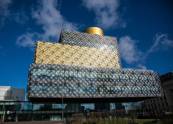 Low angle view of building against cloudy sky