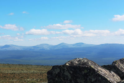 Scenic view of mountains against cloudy sky