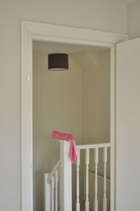 Pink glove on indoor stair railing