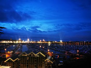 High angle view of illuminated buildings against sky at night