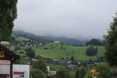 Houses on landscape against sky