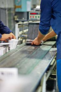 Midsection of man working on table