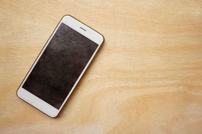 Close-up of smart phone on wooden table