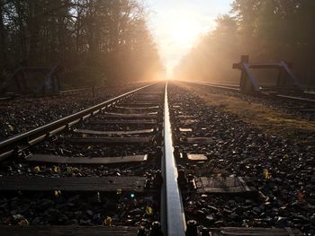 Railway tracks against sky during sunset