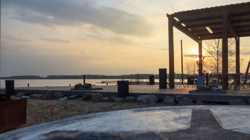 Pier over sea against sky during sunset