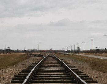 Surface level of railroad tracks against sky