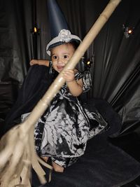 Portrait of boy holding camera at home