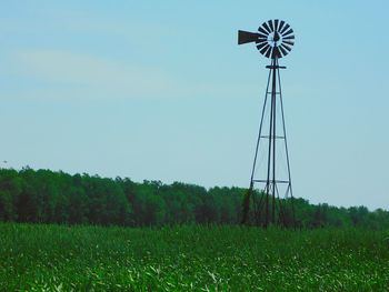 Windmill on field against clear sky