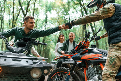 Side view of man riding motorcycle in park