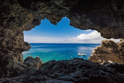 Scenic view of sea seen through rock hole