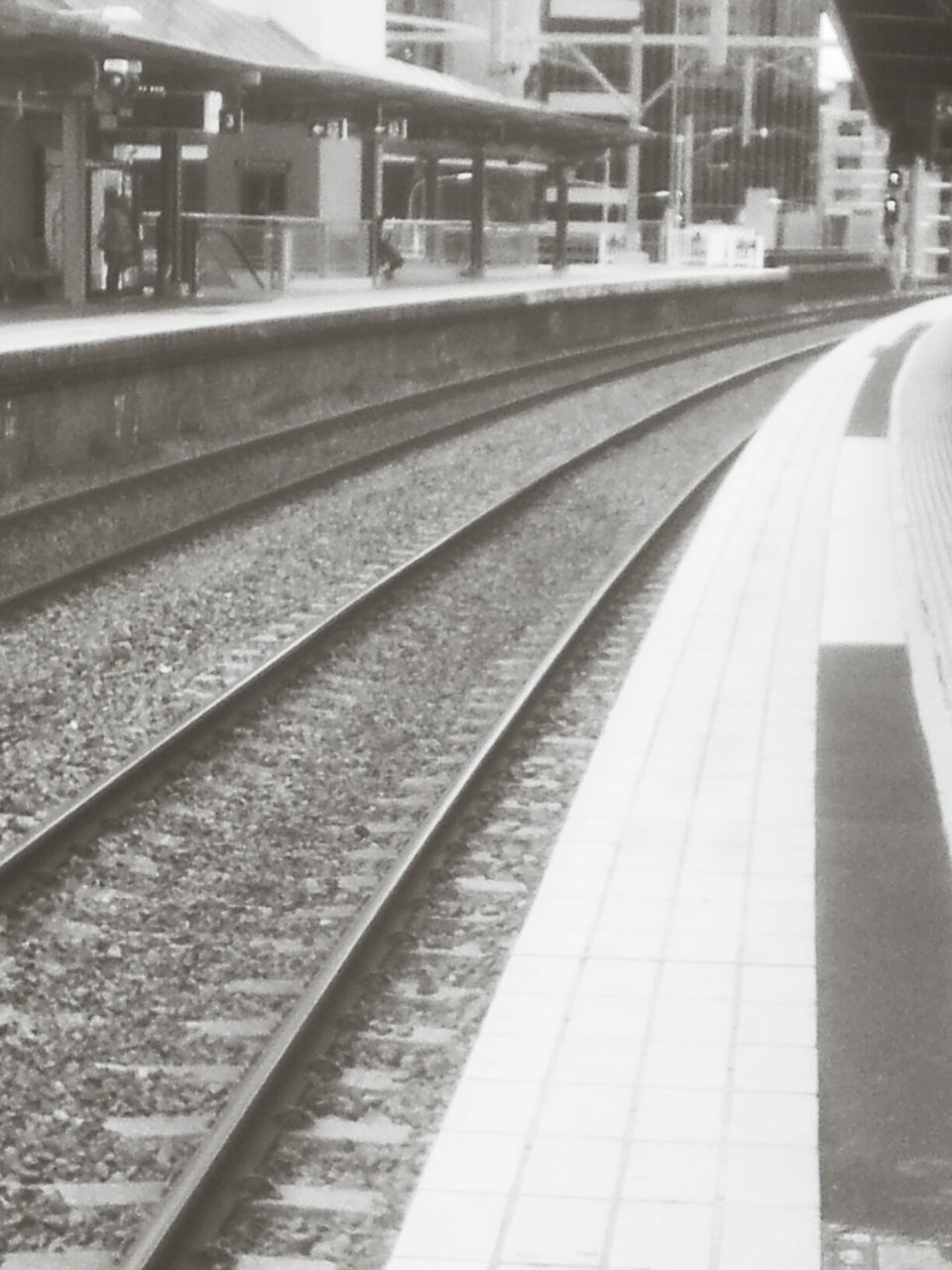 railroad track, transportation, rail transportation, public transportation, railroad station platform, railroad station, built structure, diminishing perspective, train - vehicle, architecture, mode of transport, travel, railway track, the way forward, train, subway station, passenger train, public transport, city, blurred motion