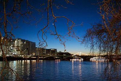 Bridge over river with buildings in background