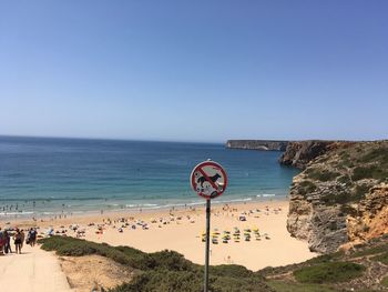 Scenic view of beach against clear blue sky