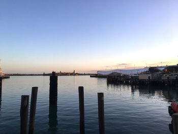 Pier on sea against sky during sunset