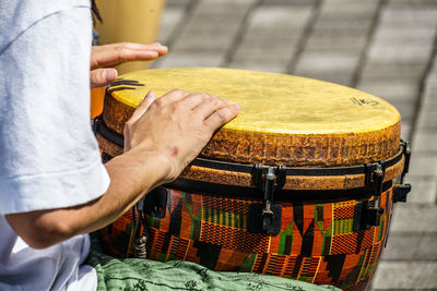 Midsection of man playing guitar