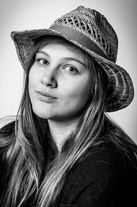 Close-up portrait of beautiful young woman wearing hat