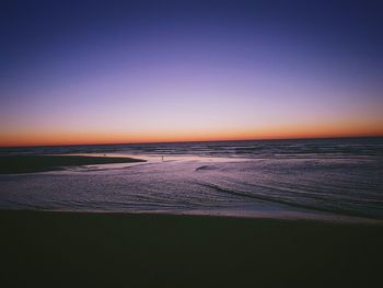 Scenic view of sea against clear sky at sunset