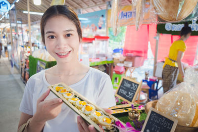 Portrait of a smiling young woman in store