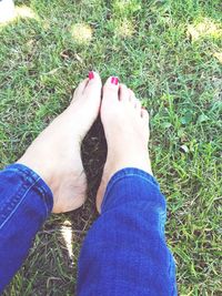 Low section of woman standing on field