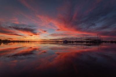 Scenic view of sea against dramatic sky during sunset