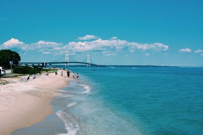 Scenic view of beach against blue sky