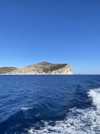 Scenic view of sea against clear blue sky