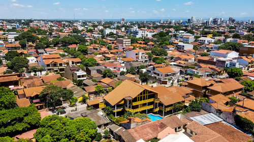 High angle view of houses and sea against sky