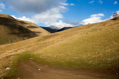 Scenic view of landscape and mountains against sky