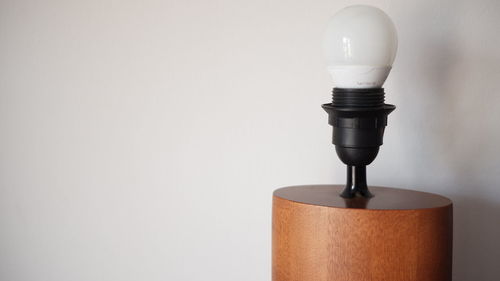 Close-up of light bulb against white background