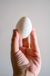 Close-up of human hand against white background