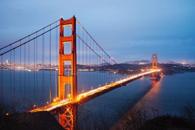 Illuminated golden gate bridge over river