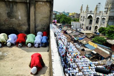 High angle view of people praying on road in city