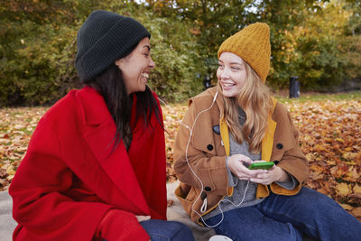 Happy friends in autumn scenery