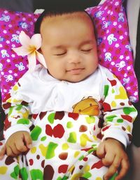 Cute baby girl sleeping on bed