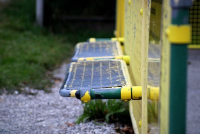 Close-up of empty bench in park