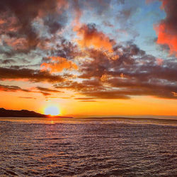 Scenic view of sea against romantic sky at sunset