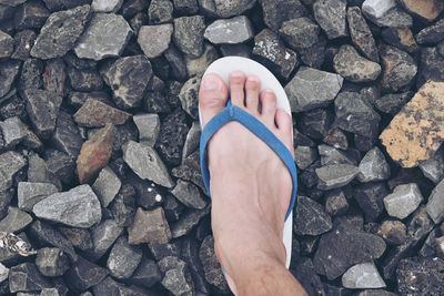 Low section of man standing on rocks