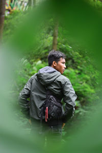Man looking at river in forest