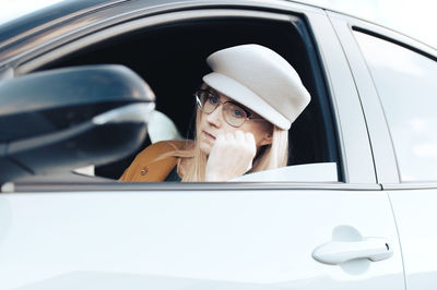 Close-up of woman using mobile phone in car