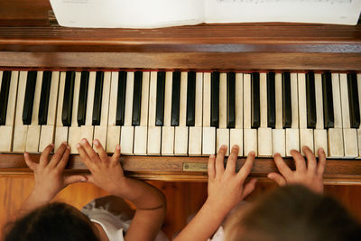 Cropped image of woman playing piano