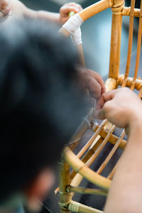 Man making bamboo chair at workshop