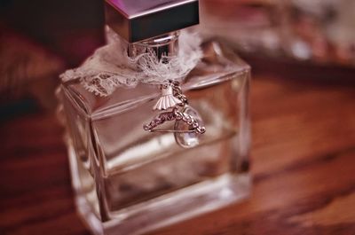 Close-up of perfume bottle on table