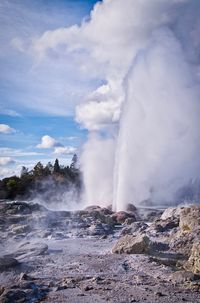 Scenic view of waterfall against sky