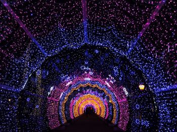 Low angle view of colorful lights at night