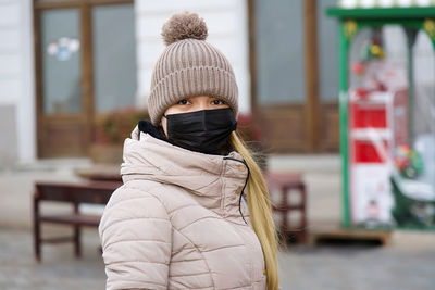 Rear view of woman standing in city