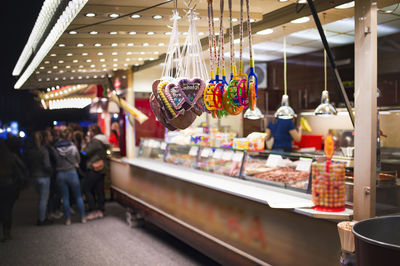 Toys with cookies hanging at market during night